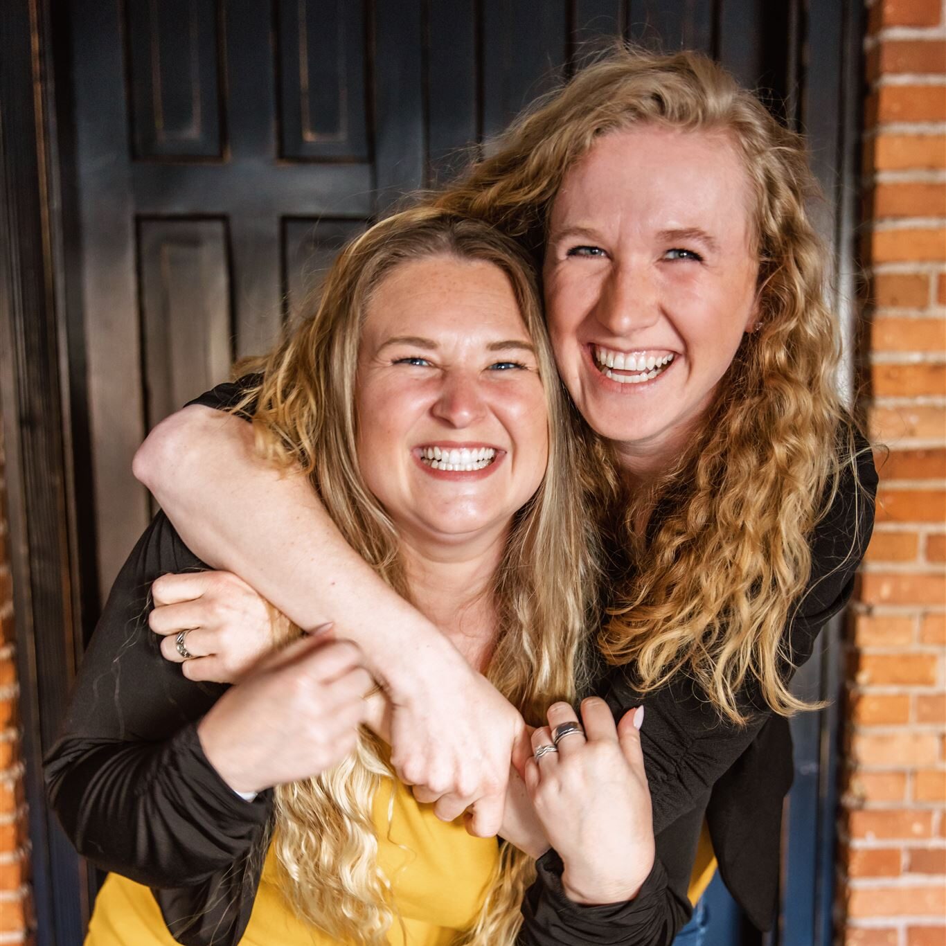Erica, photographer, and Laura, videographer, laughing together